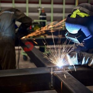 Welder performing MIG welding on a structural steel joint
