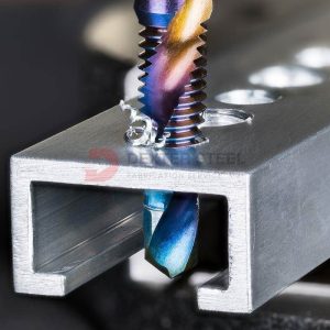 CNC drilling machine creating holes in a structural steel sectons