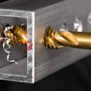 Close-up of a tap creating internal threads in a metal hole