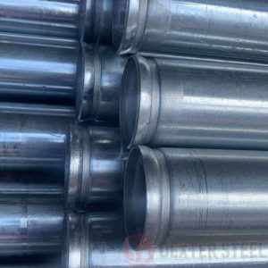 Steel tube with precision-cut grooves for mechanical couplings