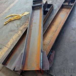 Custom welded steel beam with visible weld seams, fabricated section